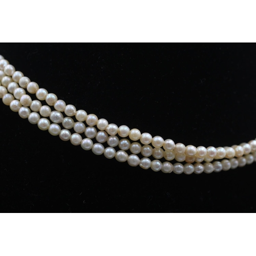 87 - A pearl three strand necklace with 9ct gold clasp - approx. gross weight 19.3 grams
