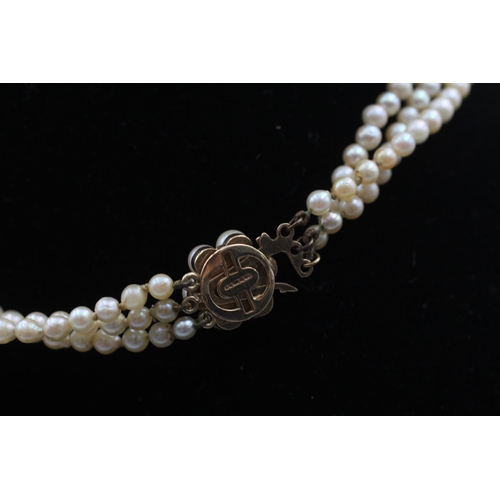 87 - A pearl three strand necklace with 9ct gold clasp - approx. gross weight 19.3 grams
