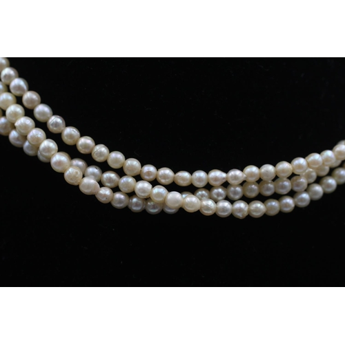 87 - A pearl three strand necklace with 9ct gold clasp - approx. gross weight 19.3 grams