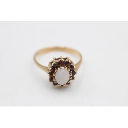 91 - A 9ct gold opal and garnet halo ring, size O - approx. gross weight 2.5 grams
