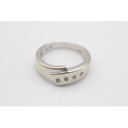 95 - A 9ct white gold diamond set cross over band ring, size M - approx. gross weight 4 grams