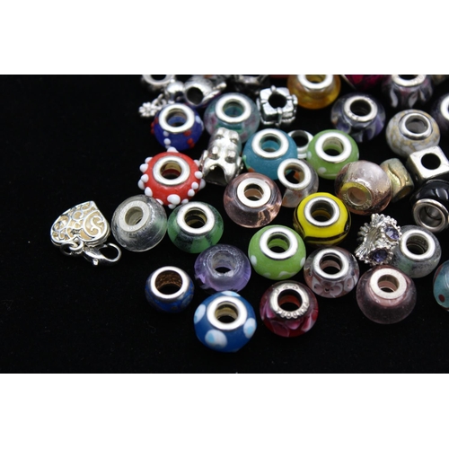104 - A large collection of bracelet charms, some stamped .925 silver
