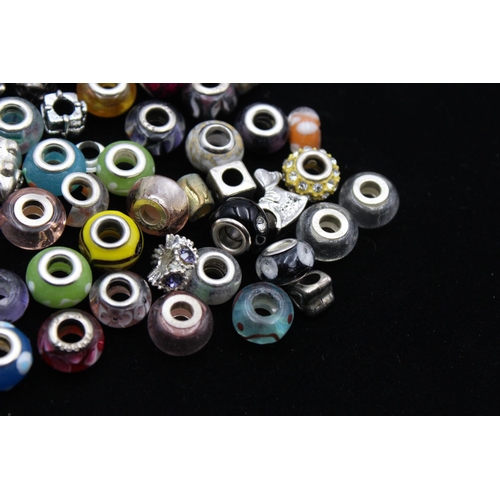 104 - A large collection of bracelet charms, some stamped .925 silver