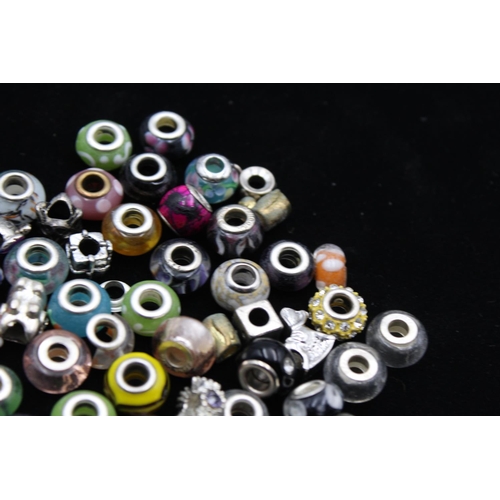 104 - A large collection of bracelet charms, some stamped .925 silver