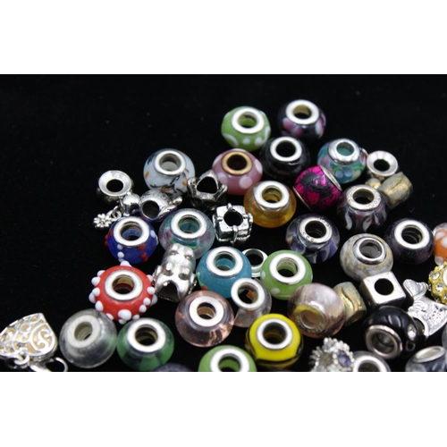 104 - A large collection of bracelet charms, some stamped .925 silver
