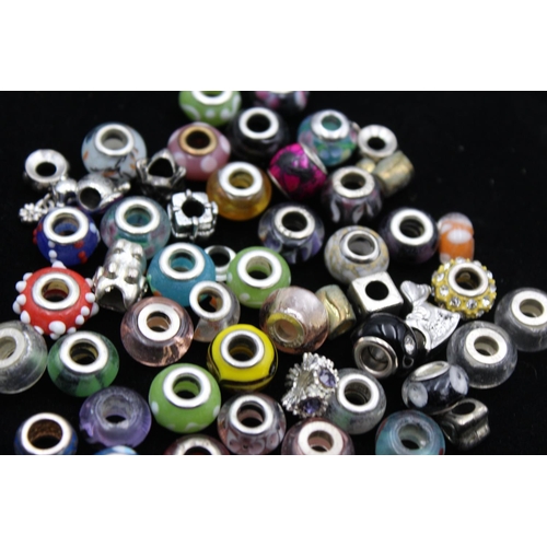 104 - A large collection of bracelet charms, some stamped .925 silver