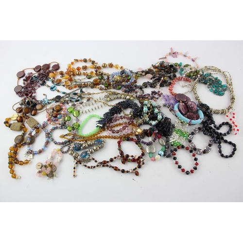 105 - Fifty pieces of assorted glass costume jewellery to include bracelets, necklaces etc.