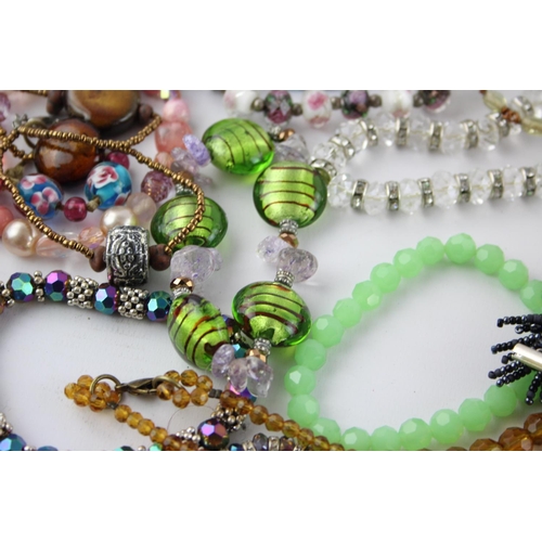 105 - Fifty pieces of assorted glass costume jewellery to include bracelets, necklaces etc.