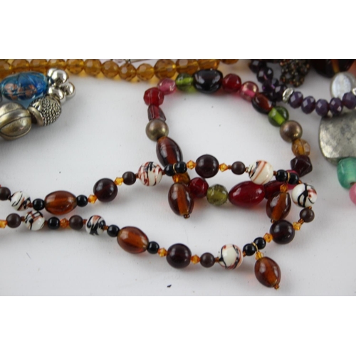 105 - Fifty pieces of assorted glass costume jewellery to include bracelets, necklaces etc.