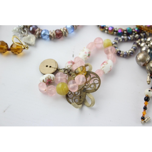105 - Fifty pieces of assorted glass costume jewellery to include bracelets, necklaces etc.