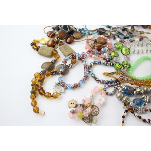 105 - Fifty pieces of assorted glass costume jewellery to include bracelets, necklaces etc.