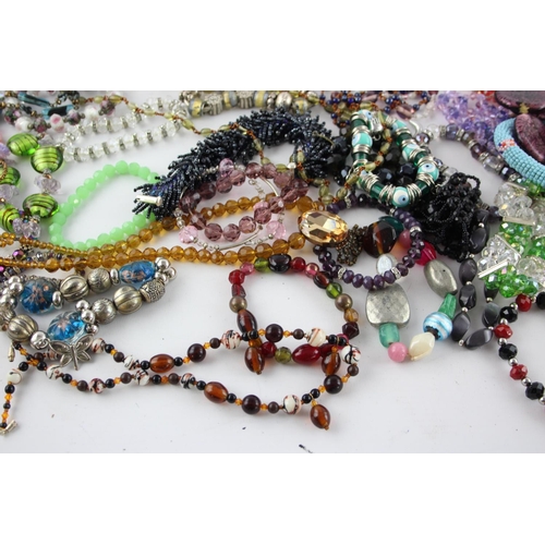 105 - Fifty pieces of assorted glass costume jewellery to include bracelets, necklaces etc.