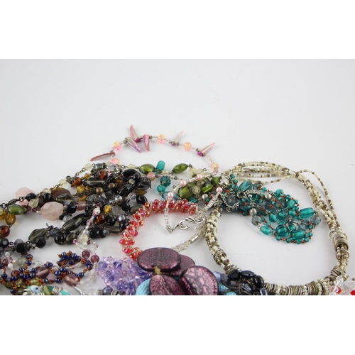 105 - Fifty pieces of assorted glass costume jewellery to include bracelets, necklaces etc.