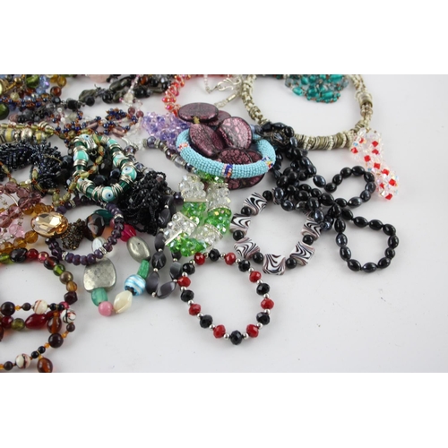 105 - Fifty pieces of assorted glass costume jewellery to include bracelets, necklaces etc.