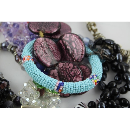 105 - Fifty pieces of assorted glass costume jewellery to include bracelets, necklaces etc.