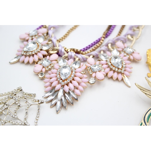 107 - Nine pieces of statement costume jewellery to include necklaces, brooches etc.