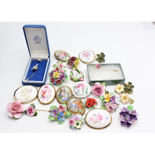 112 - Twenty five pieces of porcelain jewellery to include brooches, pins etc.