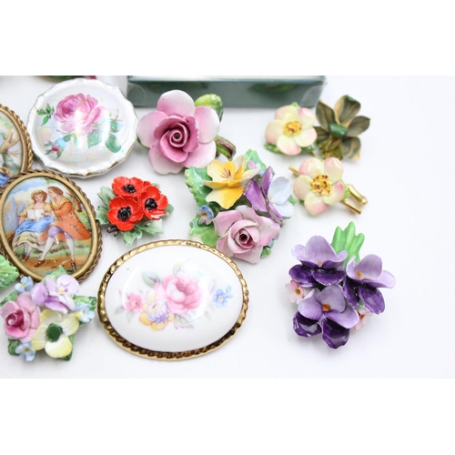 112 - Twenty five pieces of porcelain jewellery to include brooches, pins etc.