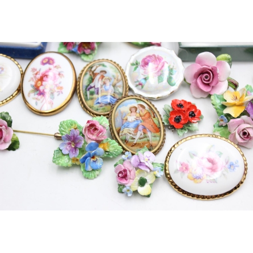 112 - Twenty five pieces of porcelain jewellery to include brooches, pins etc.