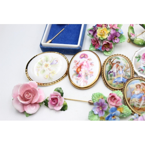 112 - Twenty five pieces of porcelain jewellery to include brooches, pins etc.