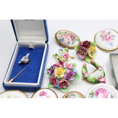 112 - Twenty five pieces of porcelain jewellery to include brooches, pins etc.