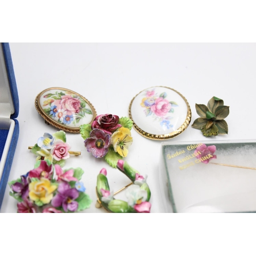 112 - Twenty five pieces of porcelain jewellery to include brooches, pins etc.