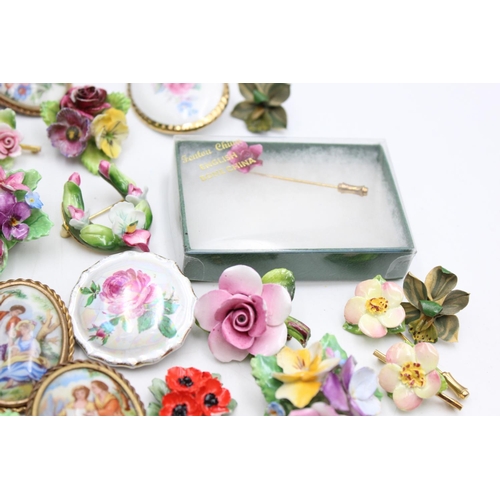 112 - Twenty five pieces of porcelain jewellery to include brooches, pins etc.