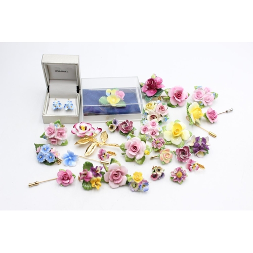 114 - Twenty five pieces of porcelain jewellery to include brooches, pins etc.