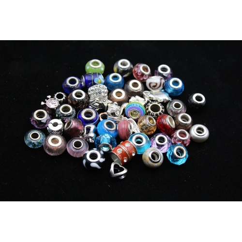 115 - A large collection of bracelet charms, some stamped .925 silver