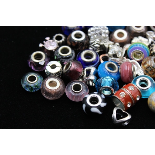115 - A large collection of bracelet charms, some stamped .925 silver