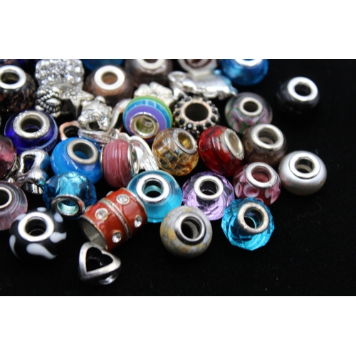 115 - A large collection of bracelet charms, some stamped .925 silver