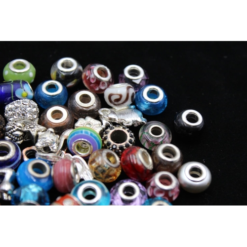115 - A large collection of bracelet charms, some stamped .925 silver