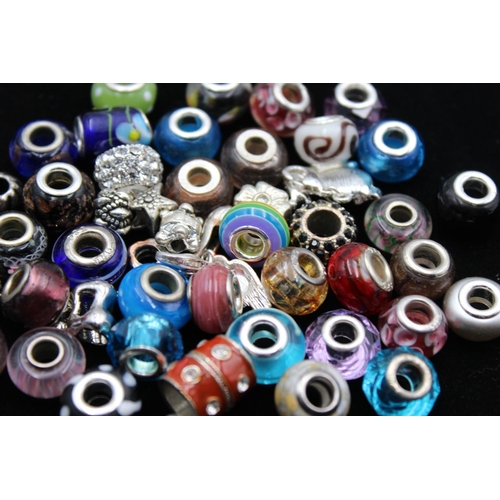 115 - A large collection of bracelet charms, some stamped .925 silver