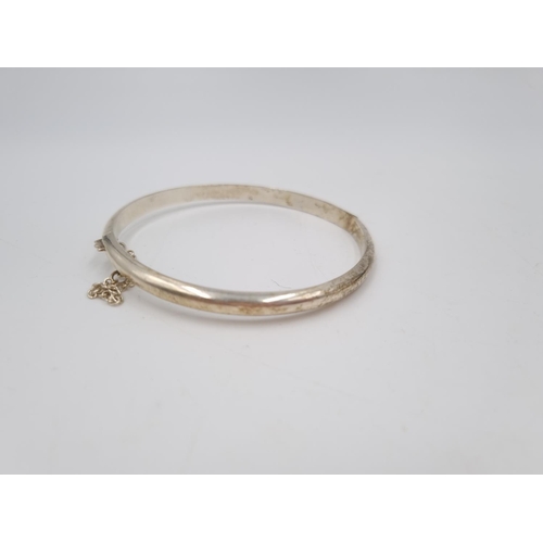 101 - A collection of .925 silver and white metal items to include three .925 silver bangles, Pandora char... 