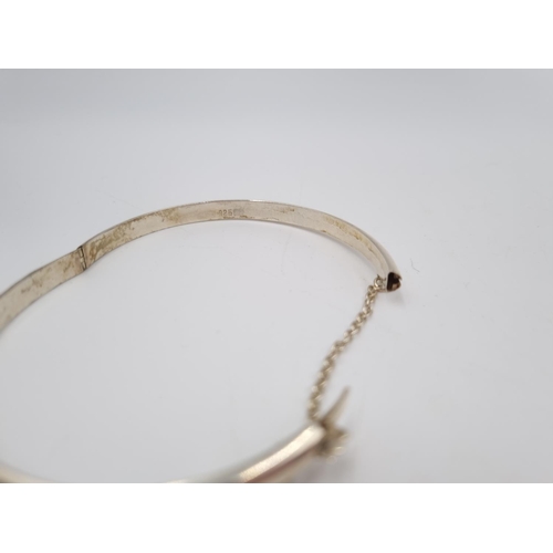 101 - A collection of .925 silver and white metal items to include three .925 silver bangles, Pandora char... 
