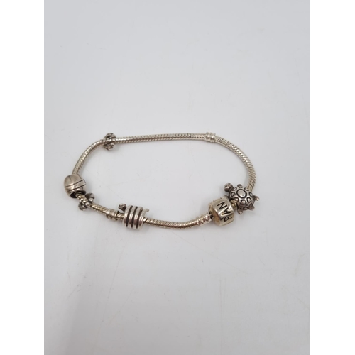 101 - A collection of .925 silver and white metal items to include three .925 silver bangles, Pandora char... 