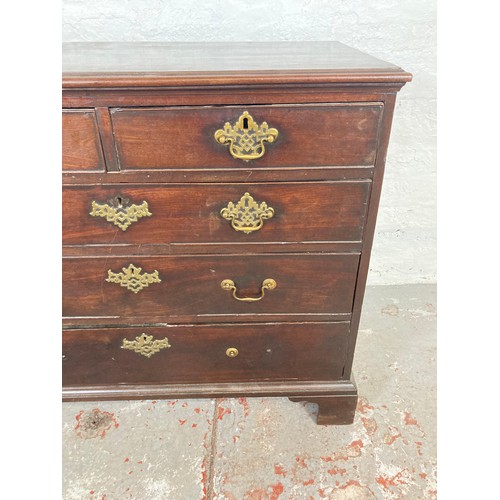 1004 - A George III mahogany chest of two short over three long drawers with bracket supports and brass han... 