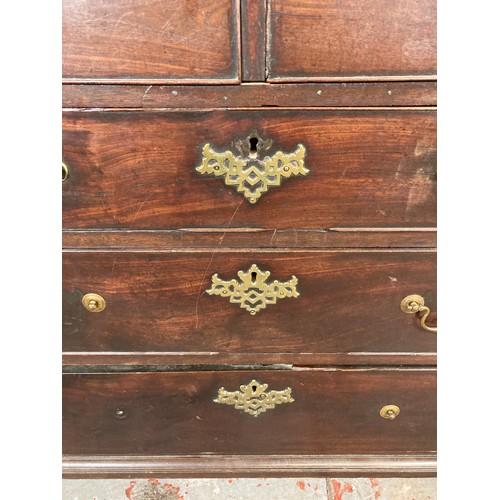 1004 - A George III mahogany chest of two short over three long drawers with bracket supports and brass han... 