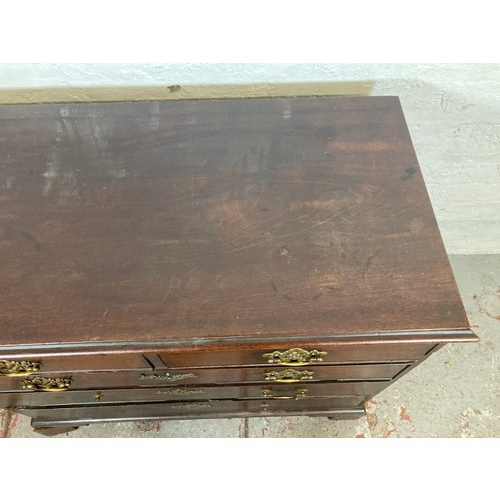 1004 - A George III mahogany chest of two short over three long drawers with bracket supports and brass han... 