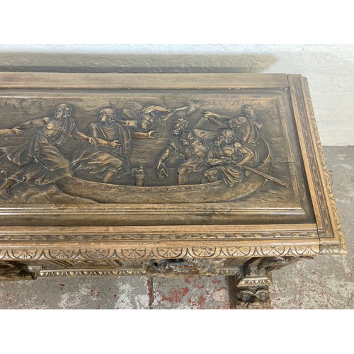 1034 - A reproduction Roman style heavily carved wooden blanket box/chest - approx. 70cm high x 136cm wide ... 