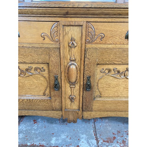 1135 - An Art Nouveau oak mirror back sideboard - approx. 167.5cm high x 151cm wide x 55.5cm deep