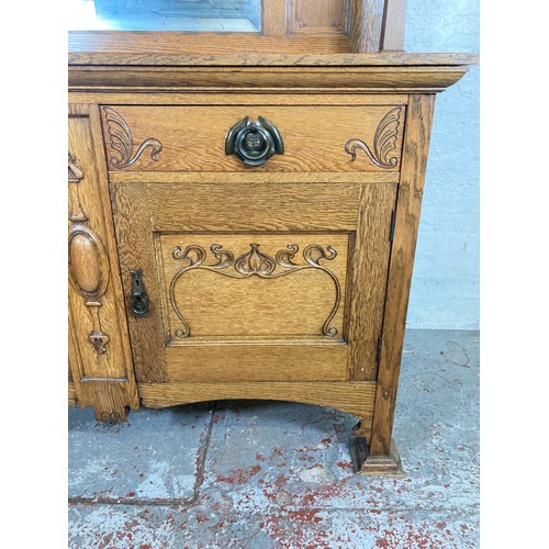 1135 - An Art Nouveau oak mirror back sideboard - approx. 167.5cm high x 151cm wide x 55.5cm deep