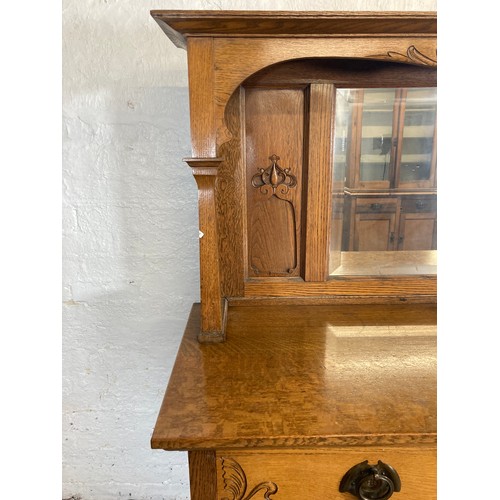 1135 - An Art Nouveau oak mirror back sideboard - approx. 167.5cm high x 151cm wide x 55.5cm deep