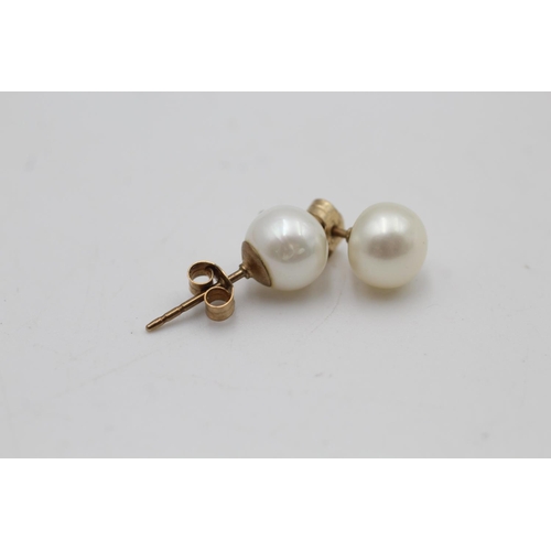 100 - A pair of 9ct gold cultured pearl stud earrings - approx. gross weight 1.9 grams