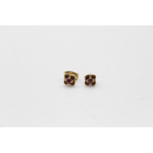 107 - Three pairs of 9ct gold gemstone stud earrings, one opal and two ruby - approx. gross weight 1.8 gra... 