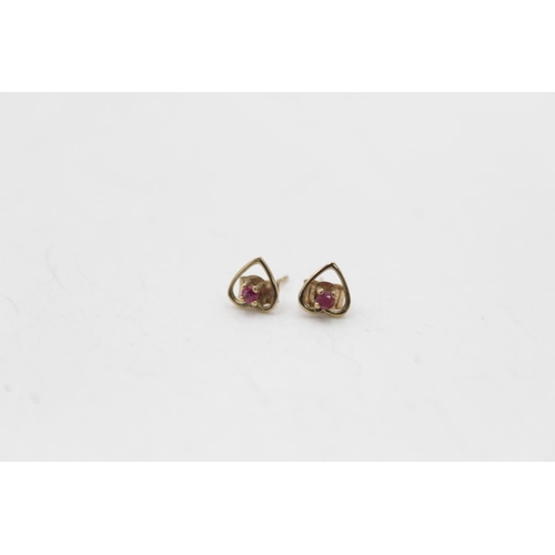 107 - Three pairs of 9ct gold gemstone stud earrings, one opal and two ruby - approx. gross weight 1.8 gra... 