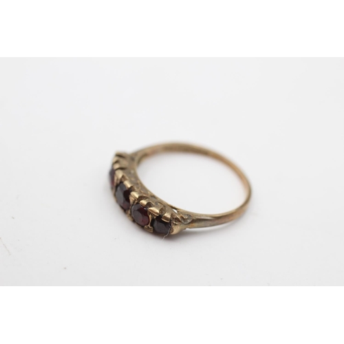 111 - A hallmarked Birmingham 9ct gold garnet five stone gypsy ring, size N - approx. gross weight 2 grams