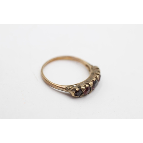 111 - A hallmarked Birmingham 9ct gold garnet five stone gypsy ring, size N - approx. gross weight 2 grams