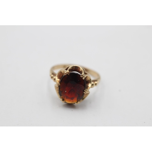 12 - A hallmarked Birmingham 9ct gold garnet dress ring, size H½ - approx. gross weight 2.1 grams