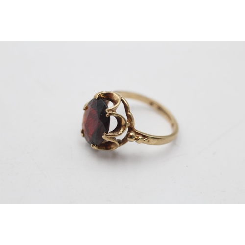 12 - A hallmarked Birmingham 9ct gold garnet dress ring, size H½ - approx. gross weight 2.1 grams